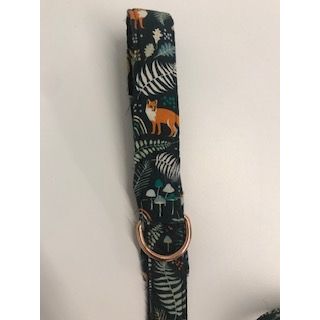 Dog collar with nature-themed design on a white background