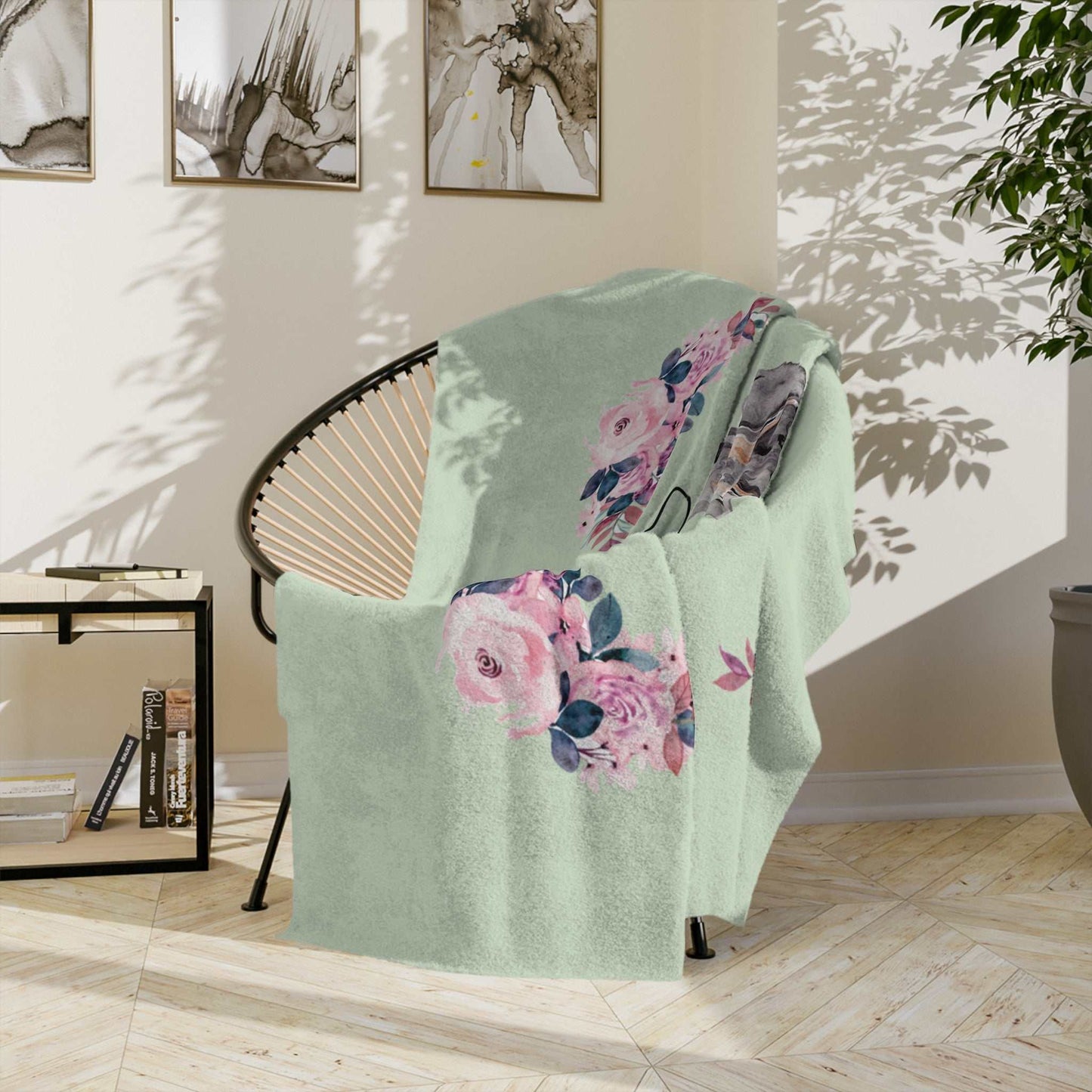Personalized fleece blanket with Dachshund and floral design draped over a chair in a cozy room.