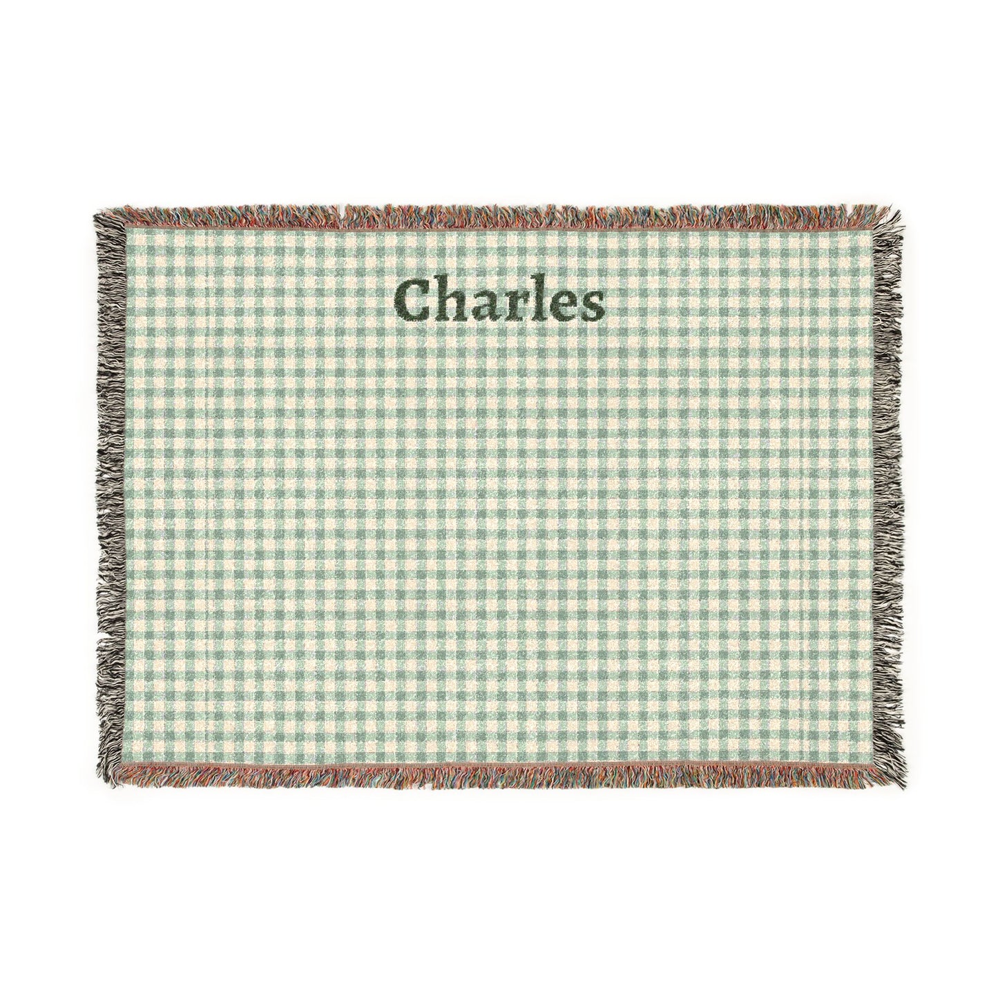 Green and white checkered blanket with 'Charles' printed on it, on a white background