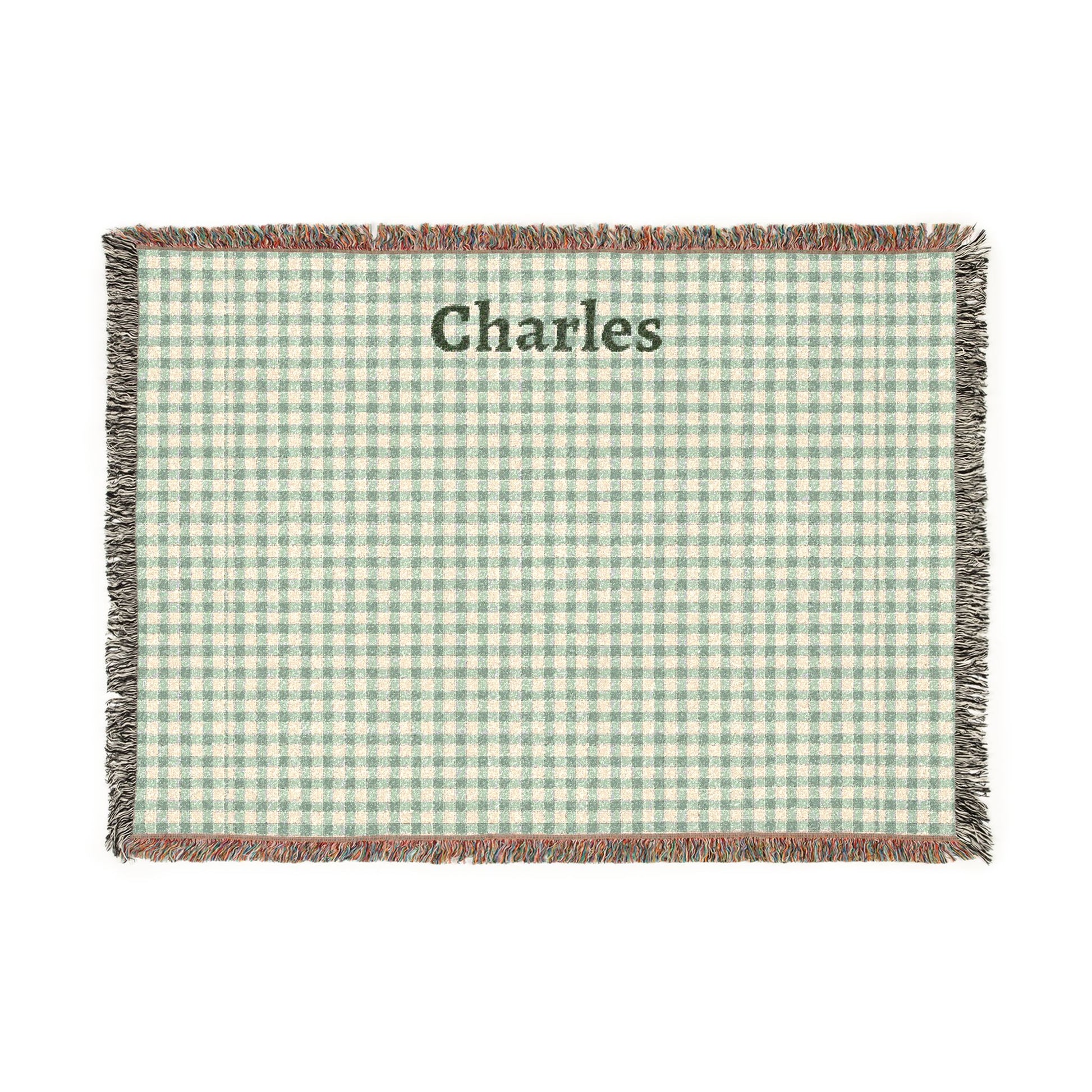Green and white checkered blanket with 'Charles' printed on it, on a white background