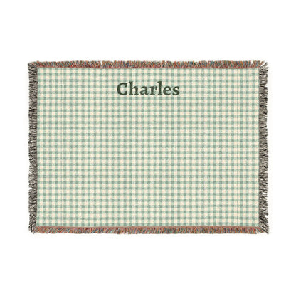 Green and white checkered blanket with 'Charles' printed on it, on a white background