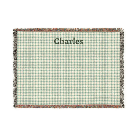 Green and white checkered blanket with 'Charles' printed on it, on a white background