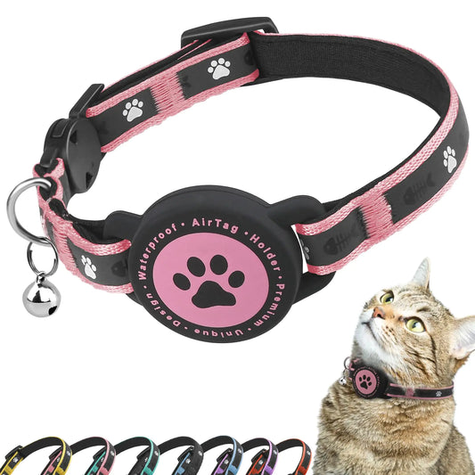 Pink and black dog collar with a tag holder and bell, featuring paw prints, on a white background.