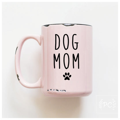 Pink mug with 'DOG MOM' text on a white background