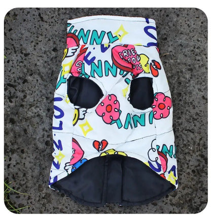Colorful doggy vest with cartoon designs on a textured surface