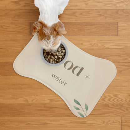 Dog drinking from a bowl on a 'Dog + Water' mat with a white background