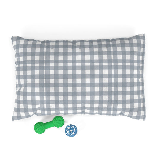 Gray and white checkered pillow pet bed with a green rubber dog toy and blue ball on a white background