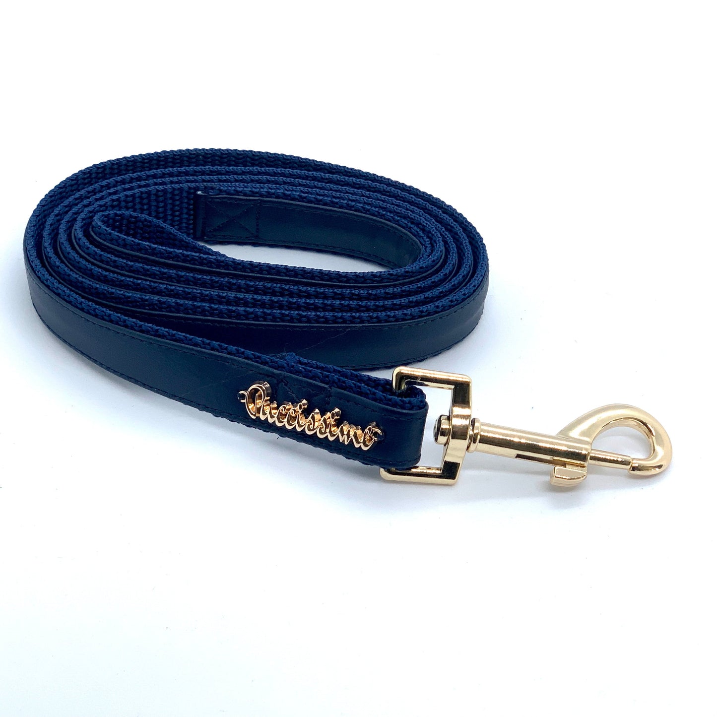 Navy blue dog leash with gold clasp on a white background