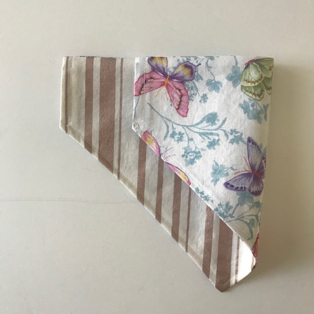 pet bandana with butterfly pattern on a plain background