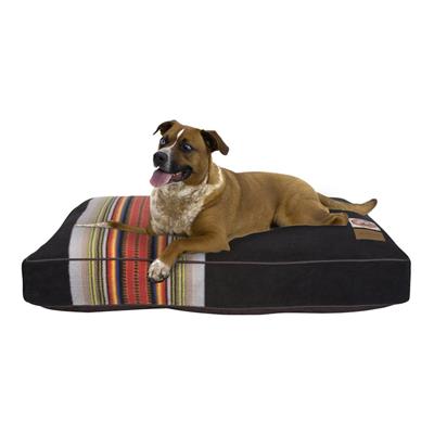 Dog lying on a striped pet bed with a white background