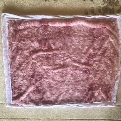 Pink textured fabric on a beige surface