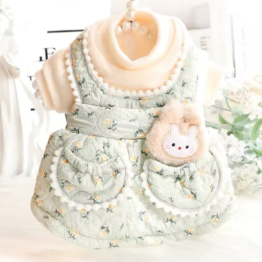 Floral-patterned dog outfit with a bunny plushie on a white background