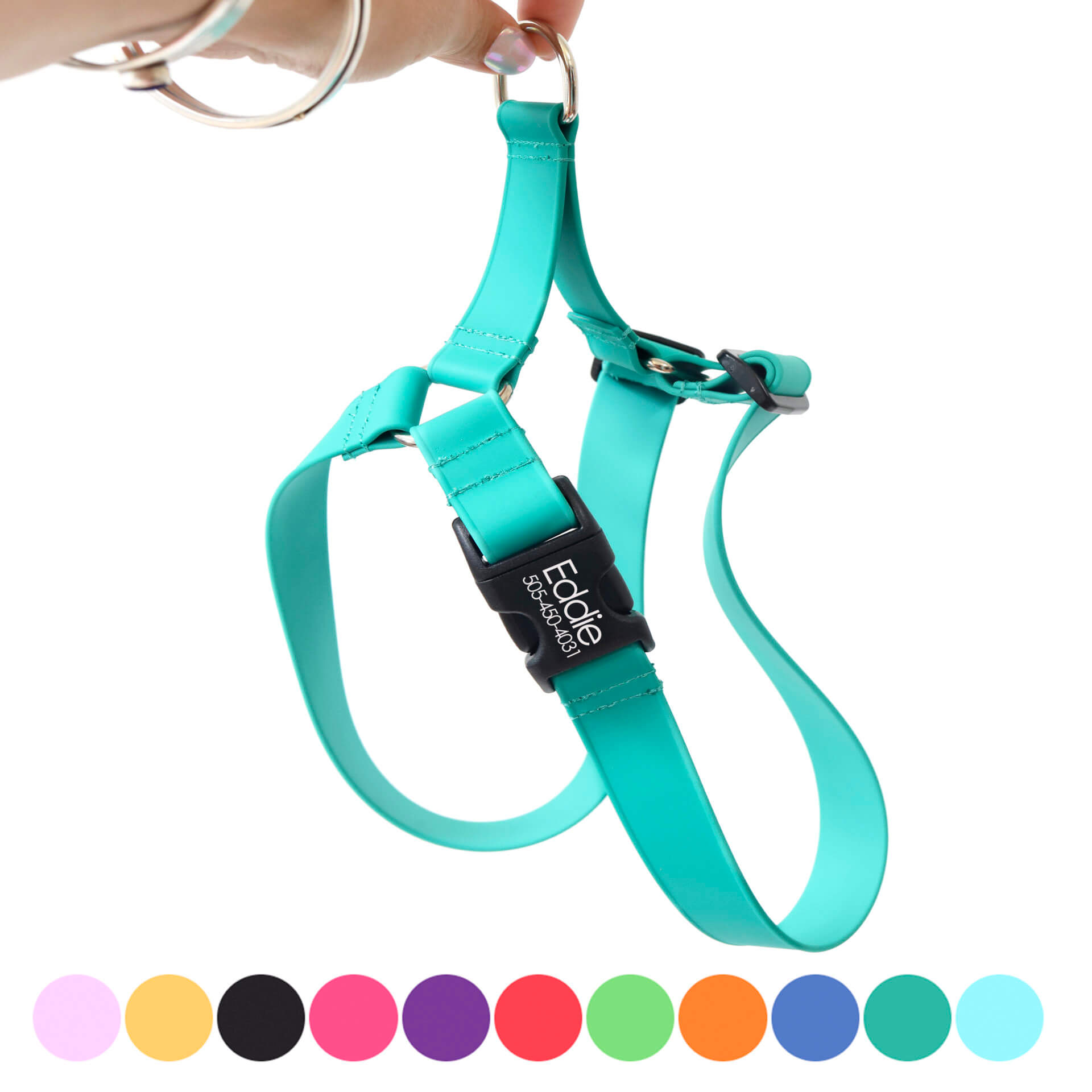 A hand holding a teal coloured waterproof dog harness