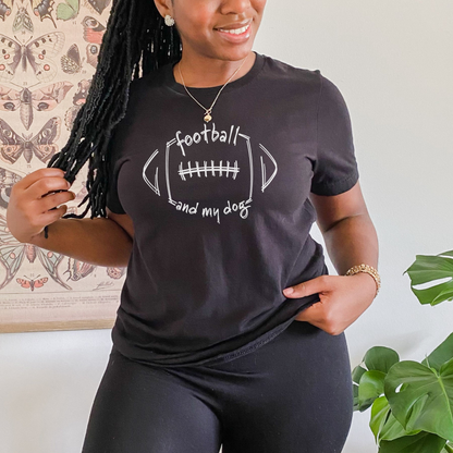 Person wearing a black t-shirt with 'football and my dog' design, standing indoors.